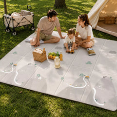 aterproof baby play mat laid on grass, family enjoying playtime outdoors on Mountain pattern side