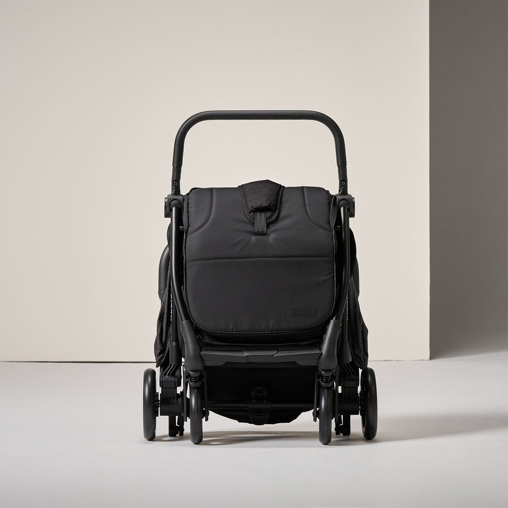 Parent quickly folding stroller with one simple motion.