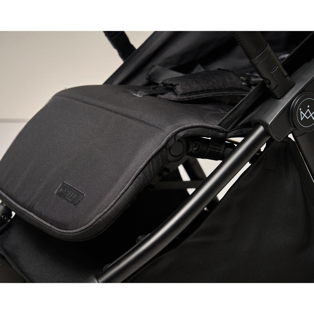 Adjustable leg support on stroller extended for toddler comfort.