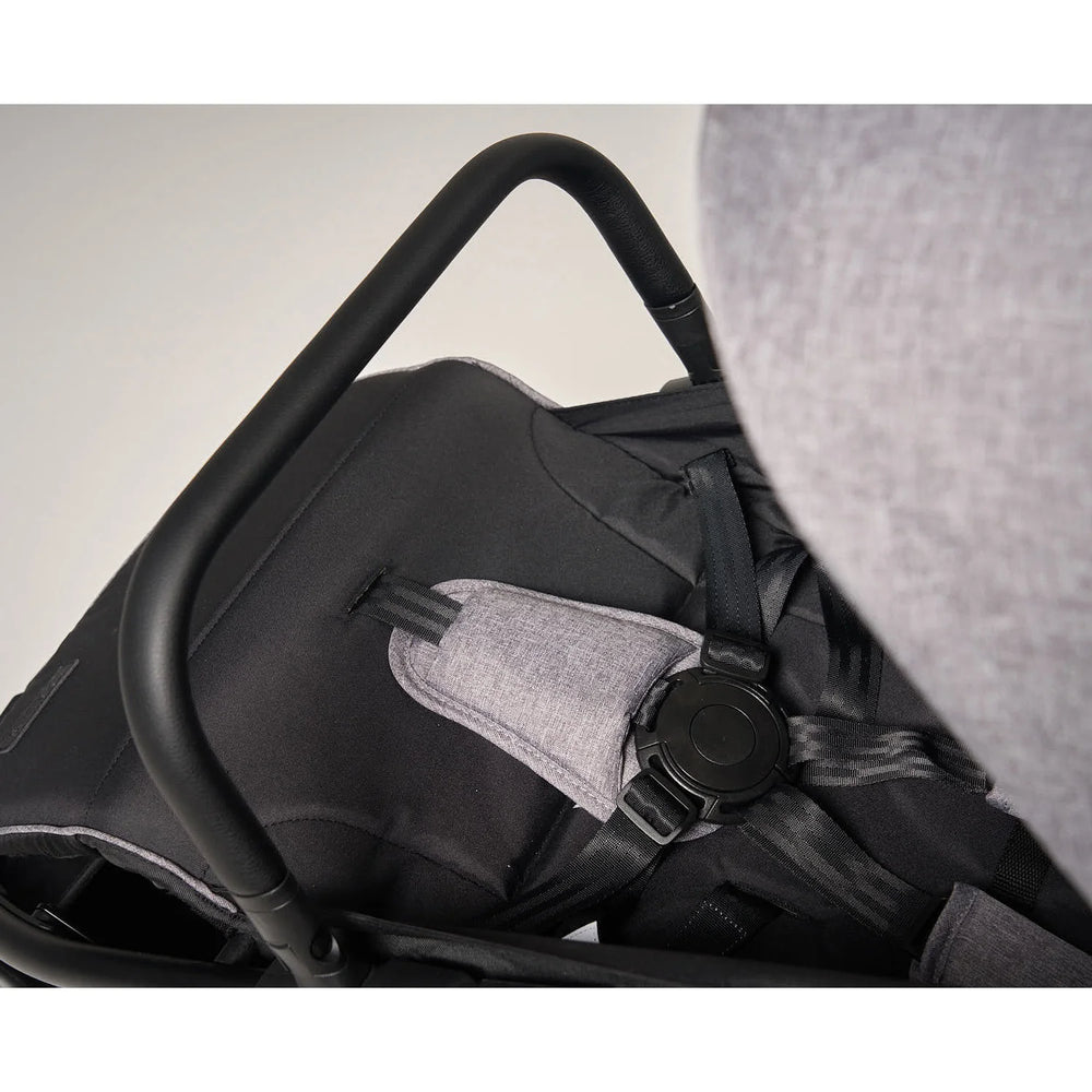 Baby safely secured with adjustable 5-point harness.