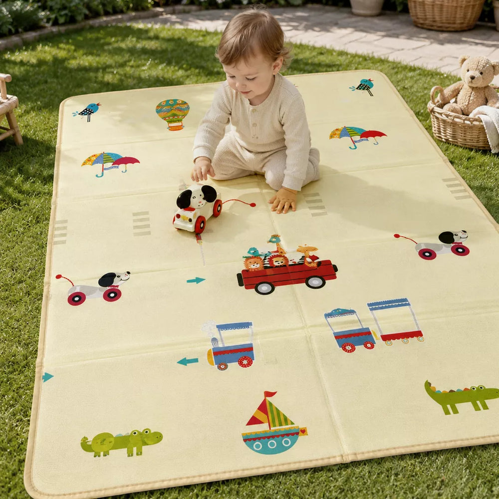 Baby playing on Allis play mat — travel theme side with cars, trains & fun route designs